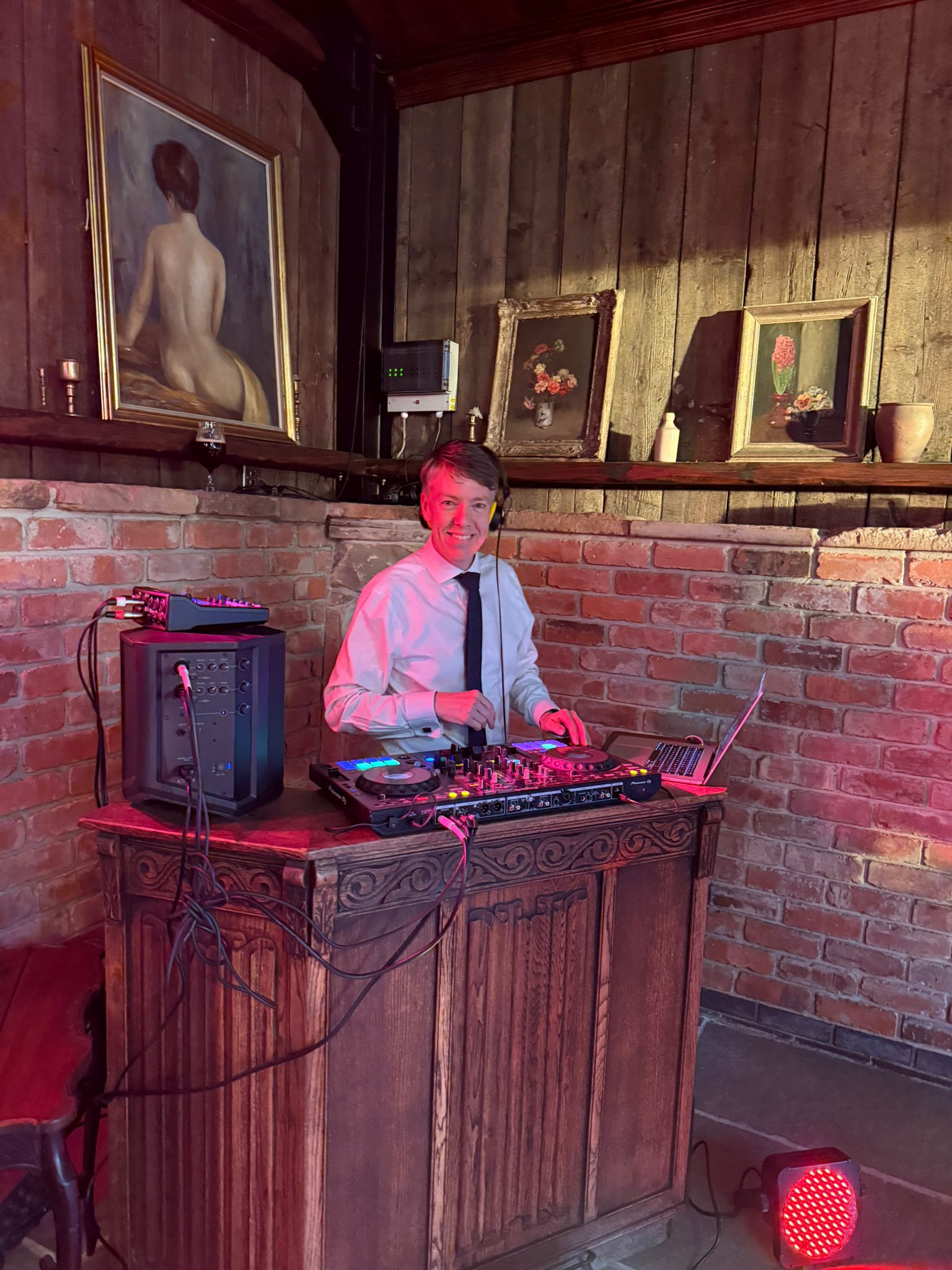 Paul Rayner DJing at a wedding in a tie